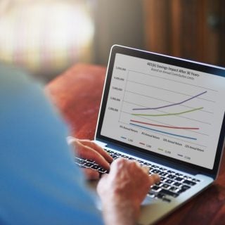Man managing retirement plan on laptop